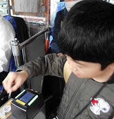 運賃箱にお金を入れています